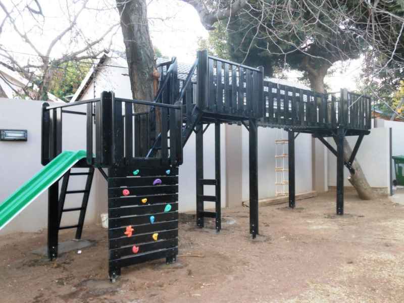1 - Wooden Platform in trees with supported beams and accessories.