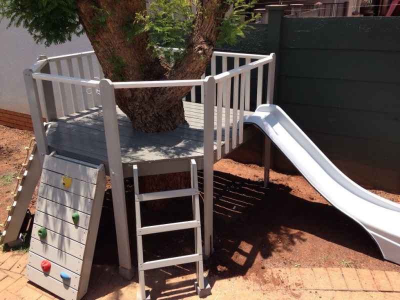 5 - Small children Platform around the tree with a Climbing wall, small Slide, and Ramp with Rope.